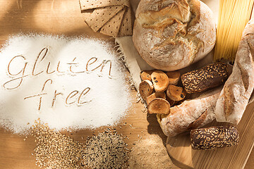 Image showing Gluten free food. Various pasta, bread and snacks on wooden background from top view