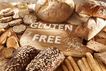 Image showing Gluten free food. Various pasta, bread and snacks on wooden background from top view