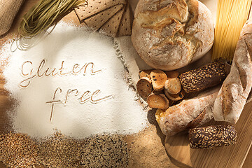 Image showing Gluten free food. Various pasta, bread and snacks on wooden background from top view