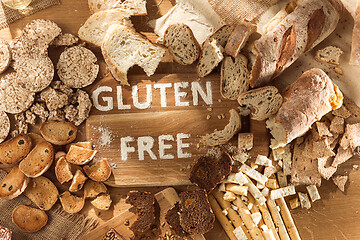 Image showing Gluten free food. Various pasta, bread and snacks on wooden background from top view