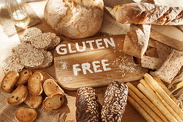 Image showing Gluten free food. Various pasta, bread and snacks on wooden background from top view