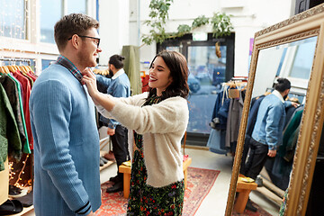 Image showing couple choosing clothes at vintage clothing store