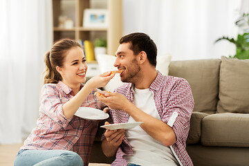 Image showing happy couple eating pizza at home