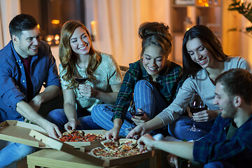 Image showing friends eating pizza and drinking wine at home