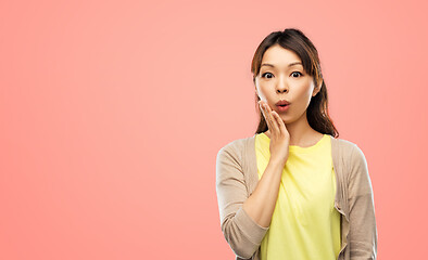 Image showing surprised asian woman over grey background