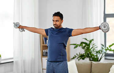 Image showing indian man exercising with dumbbells at home