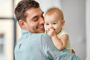 Image showing happy father holding little baby daughter at home