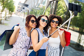 Image showing women with shopping bags taking selfie outdoors