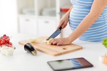 Image showing close up of pregnant woman cooking food at home