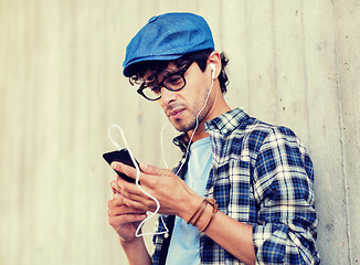 Image showing man with earphones and smartphone listening music