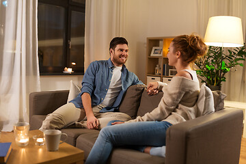 Image showing happy couple talking at home in evening