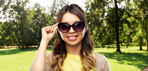 Image showing happy smiling young asian woman in sunglasses