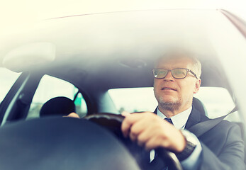 Image showing happy senior businessman driving car