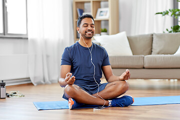 Image showing indian man meditating in lotus pose at home