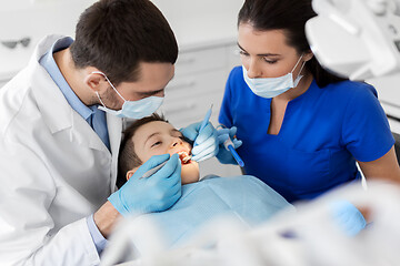 Image showing dentist checking for kid teeth at dental clinic