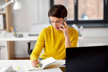 Image showing businesswoman calling on smartphone at office