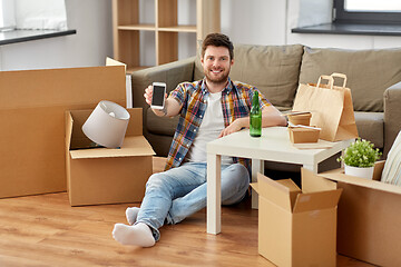 Image showing man with smartphone and takeaway food moving