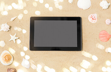 Image showing tablet computer and seashells on beach sand
