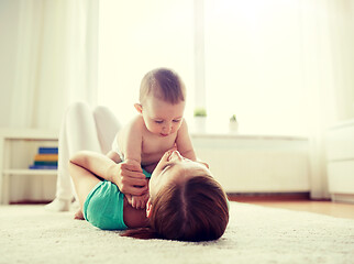 Image showing happy mother playing with baby at home