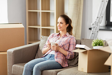 Image showing woman moving to new home and drinking coffee