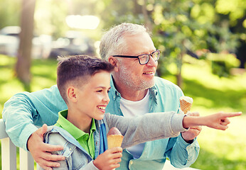 Image showing old man and boy eating ice cream at summer park