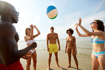Image showing happy friends playing ball on summer beach