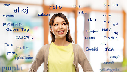 Image showing asian woman looking up over foreign languages