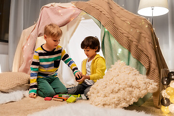 Image showing boys playing toy blocks in kids tent at home