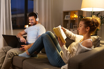 Image showing couple with laptop computer and book at home