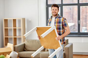 Image showing happy man with table moving to new home