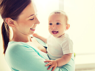 Image showing happy young mother with little baby at home