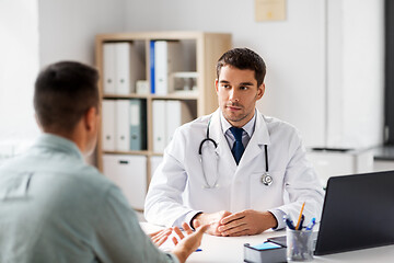 Image showing doctor with laptop and male patient at hospital