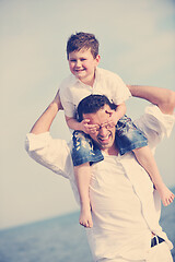 Image showing happy father and son have fun and enjoy time on beach