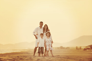 Image showing happy young family have fun on beach at sunset