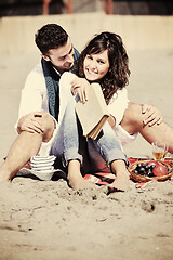 Image showing young couple enjoying  picnic on the beach