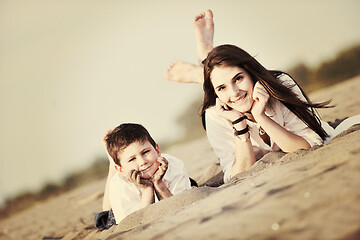 Image showing mom and son relaxing on beach