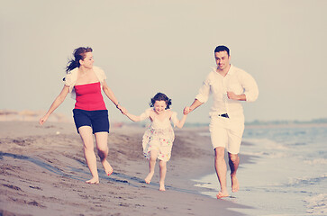 Image showing happy young family have fun on beach