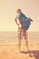 Image showing funny superhero standing on beach