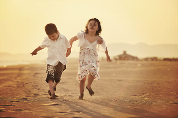 Image showing happy young family have fun on beach at sunset