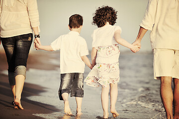 Image showing happy young family have fun on beach at sunset