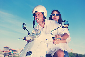 Image showing Portrait of happy young love couple on scooter enjoying summer t