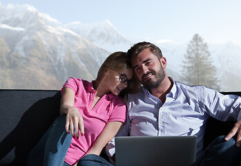 Image showing couple relaxing at  home using laptop computers