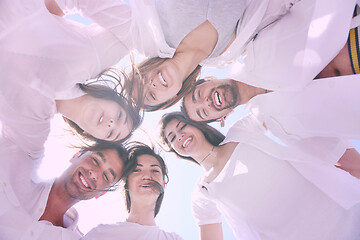 Image showing Group of happy young people in circle at beach