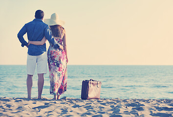 Image showing couple on beach with travel bag