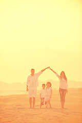 Image showing happy young family have fun on beach at sunset