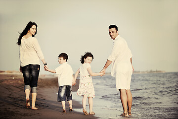 Image showing happy young family have fun on beach