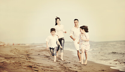 Image showing happy young family have fun on beach