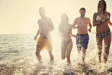 Image showing happy people group have fun and running on beach