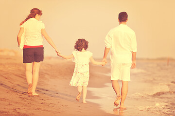 Image showing happy young family have fun on beach