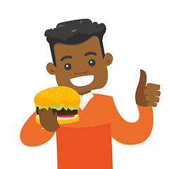 Image showing Young african-american man eating hamburger.